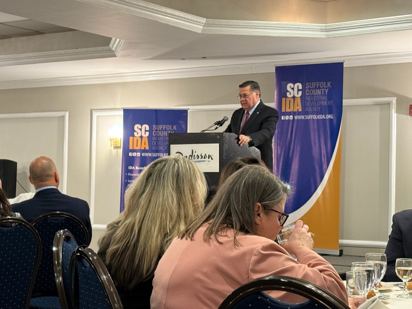 Ed Romaine at podium